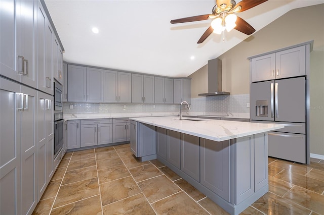 kitchen featuring gray cabinets, stainless steel appliances, and wall chimney exhaust hood