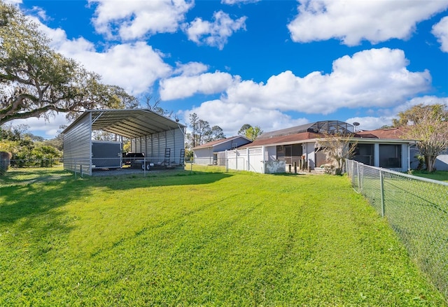 view of yard with a carport and an outdoor structure