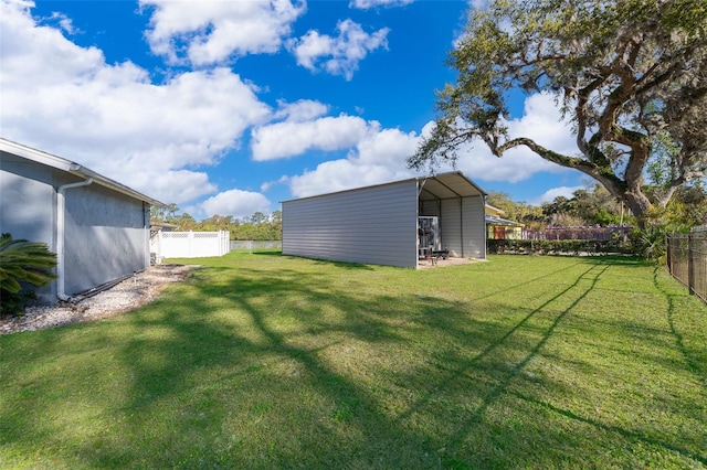 view of yard with a carport and a fenced backyard