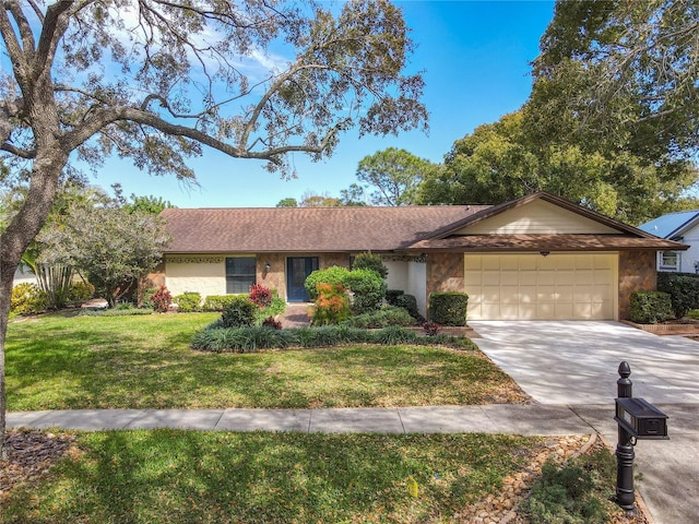 single story home with a garage, driveway, a front yard, and stone siding