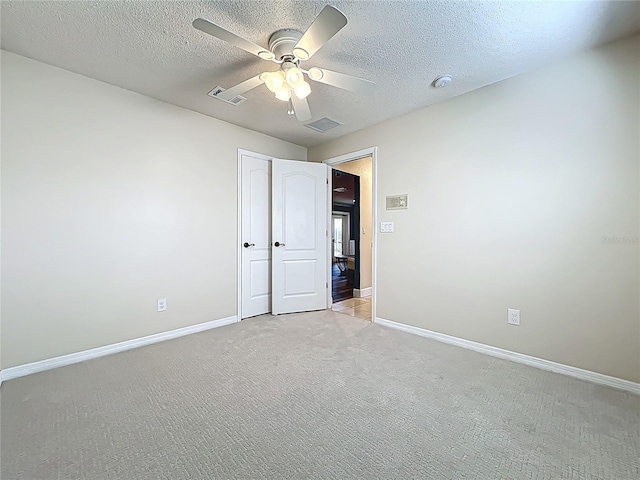 unfurnished bedroom with visible vents, light carpet, and baseboards