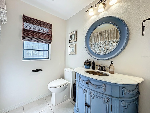 bathroom with vanity, tile patterned floors, toilet, and baseboards