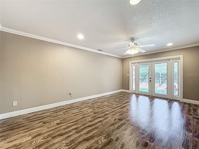 spare room featuring ornamental molding, french doors, dark wood-style flooring, and baseboards