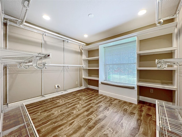 spacious closet with wood finished floors