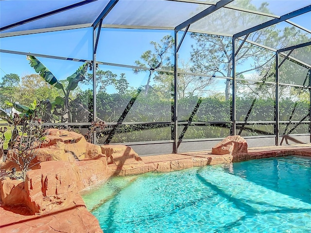 outdoor pool featuring a lanai and a patio area