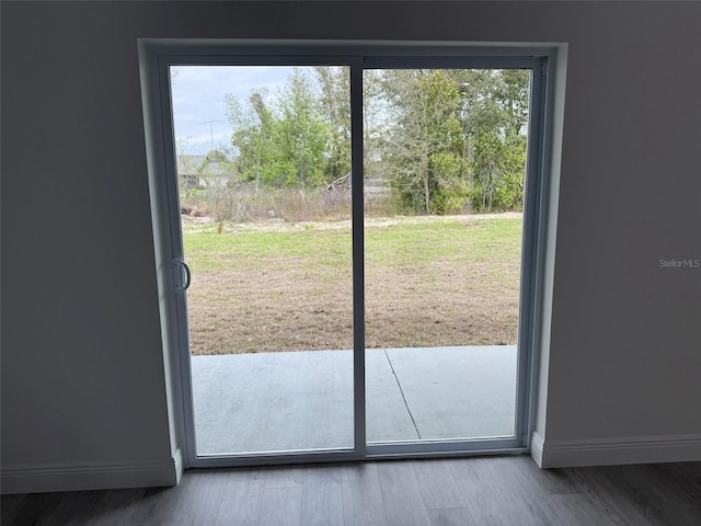 entryway with baseboards and wood finished floors