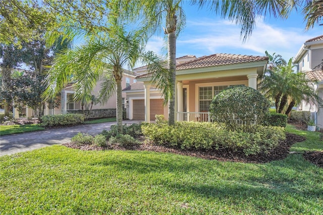 mediterranean / spanish house with stucco siding, a front lawn, decorative driveway, a garage, and a tiled roof