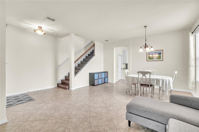 living room with visible vents, baseboards, a chandelier, stairway, and tile patterned floors