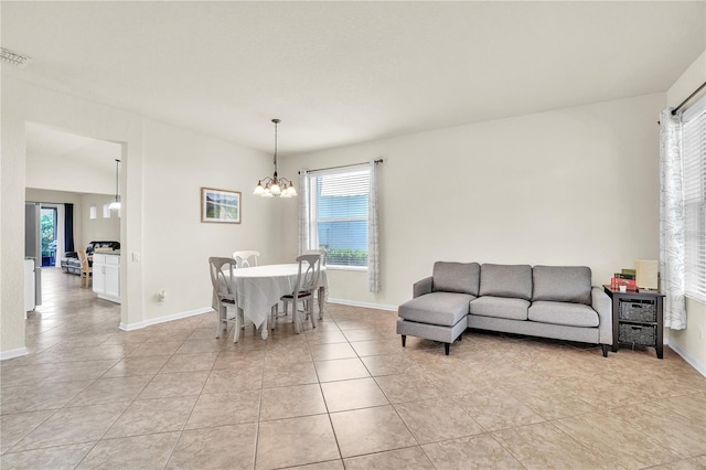 dining space featuring visible vents, baseboards, a notable chandelier, and light tile patterned flooring