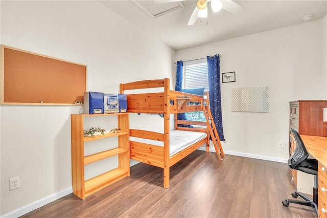 bedroom with attic access, wood finished floors, baseboards, and ceiling fan