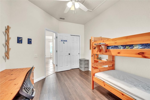 bedroom featuring visible vents, wood finished floors, a closet, baseboards, and ceiling fan