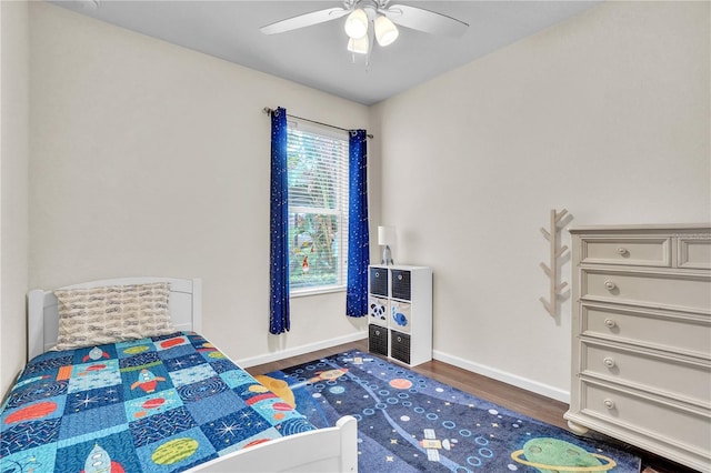 bedroom with baseboards, wood finished floors, and a ceiling fan