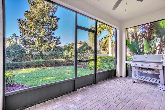 unfurnished sunroom with a ceiling fan