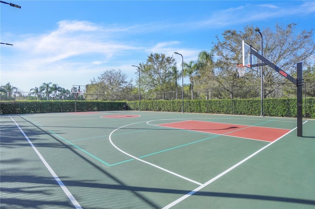 view of basketball court with community basketball court and fence