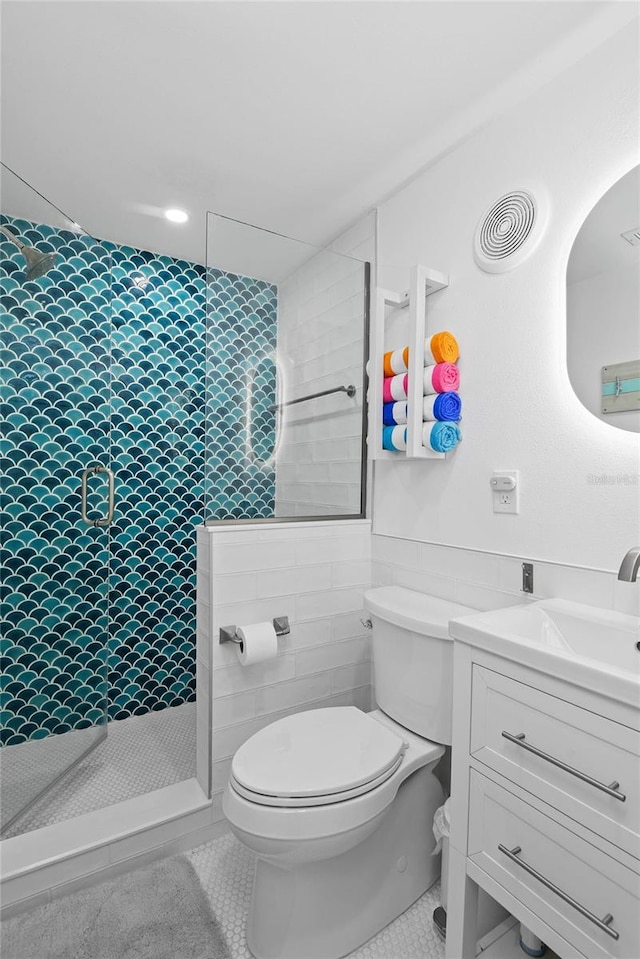 full bathroom with vanity, visible vents, a tile shower, tile patterned flooring, and toilet