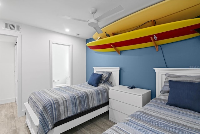 bedroom featuring visible vents, a ceiling fan, ensuite bath, wood finished floors, and recessed lighting