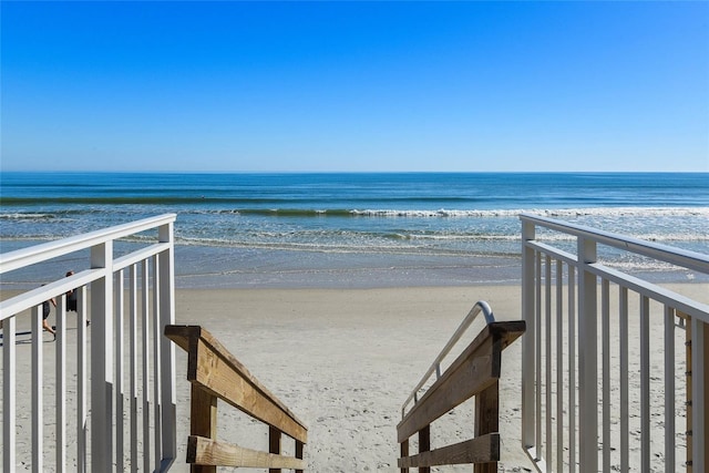 view of property's community with a view of the beach and a water view