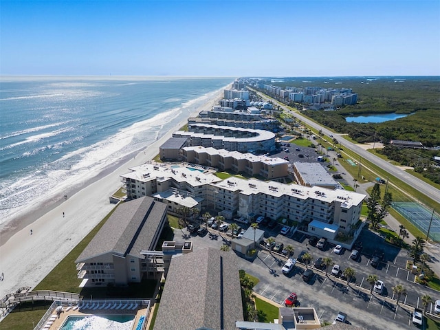 bird's eye view featuring a water view and a beach view