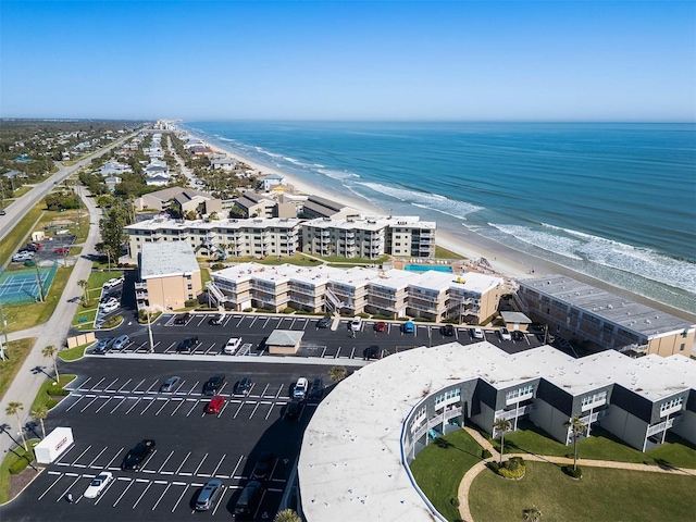 birds eye view of property with a view of the beach and a water view