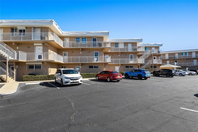 view of building exterior with uncovered parking