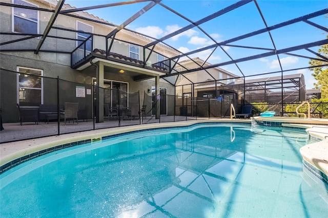 outdoor pool featuring a lanai and a patio area