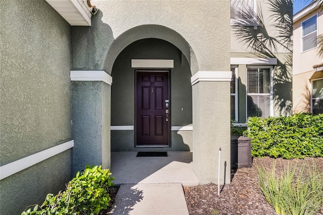 doorway to property with stucco siding