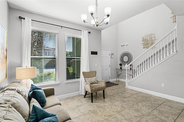 interior space with light tile patterned floors, stairway, baseboards, and an inviting chandelier