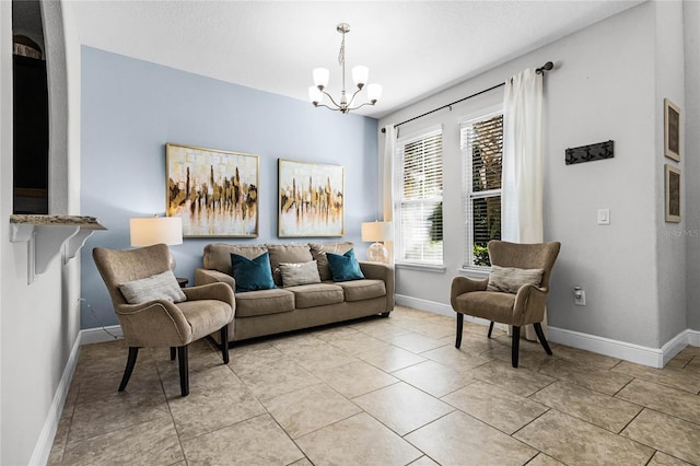 living area featuring light tile patterned flooring, baseboards, and a chandelier