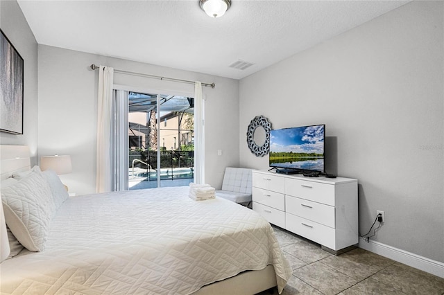 bedroom featuring visible vents, baseboards, light tile patterned floors, a textured ceiling, and access to outside