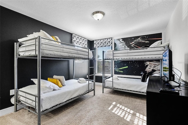 bedroom featuring carpet, baseboards, and a textured ceiling