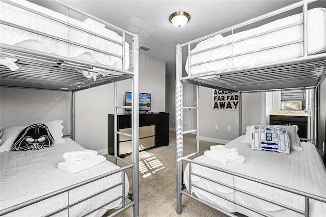 bedroom with baseboards, visible vents, and a textured ceiling