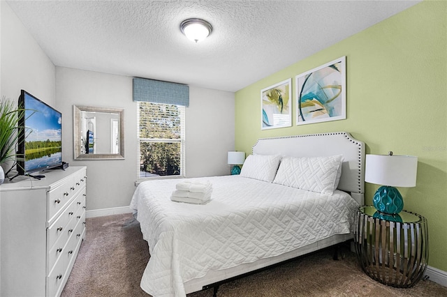 bedroom featuring baseboards, carpet floors, and a textured ceiling