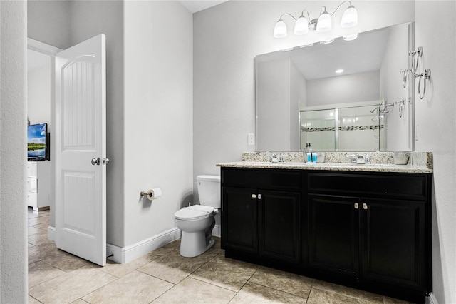 bathroom with tile patterned floors, toilet, a shower stall, baseboards, and vanity