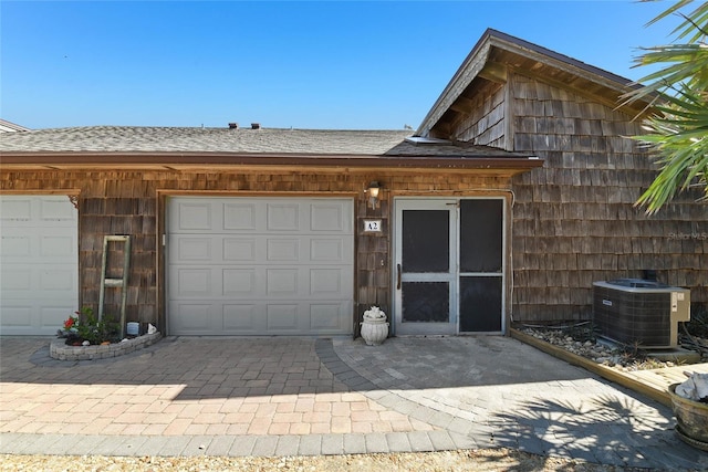 exterior space featuring central air condition unit and driveway