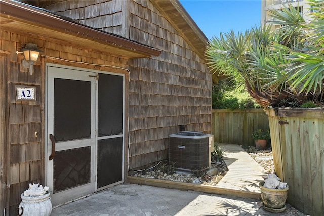 exterior space with central air condition unit and fence