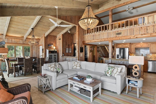 living room with stairway, wooden walls, wooden ceiling, and ceiling fan with notable chandelier