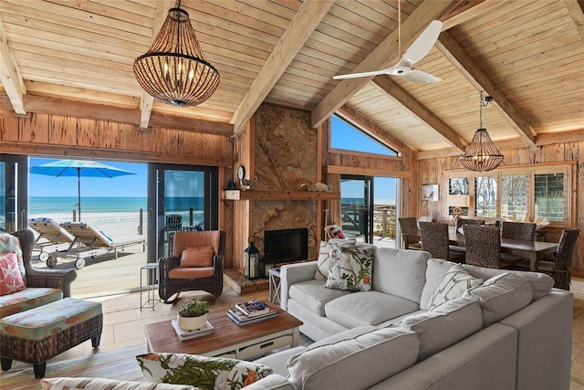 living room featuring beamed ceiling, a water view, wood walls, and wooden ceiling