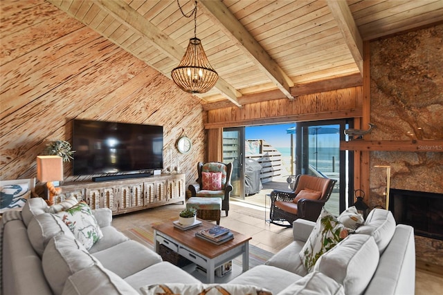 unfurnished living room with wooden walls, vaulted ceiling with beams, a high end fireplace, wood ceiling, and a chandelier