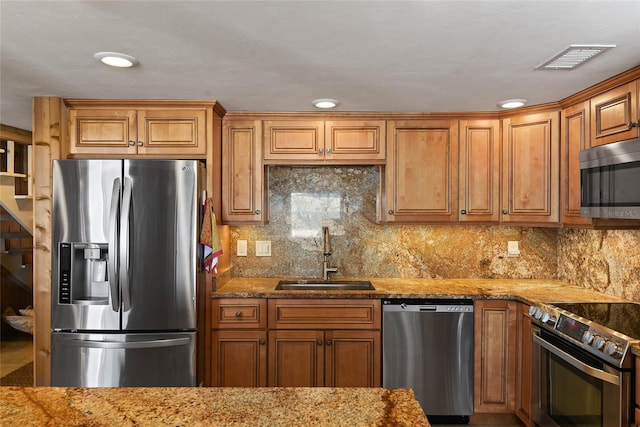 kitchen featuring a sink, visible vents, backsplash, and stainless steel appliances