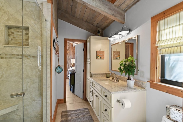 bathroom with tile patterned floors, vanity, vaulted ceiling with beams, and a tile shower