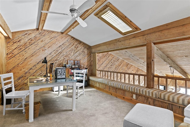 home office with wood walls, vaulted ceiling with beams, and a ceiling fan