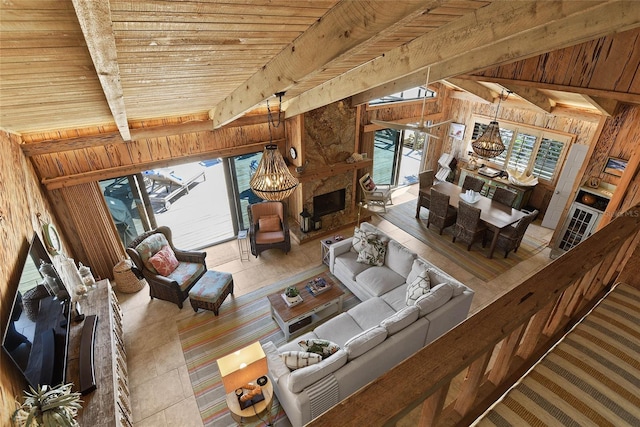 living area with wooden ceiling, wooden walls, beamed ceiling, and a chandelier