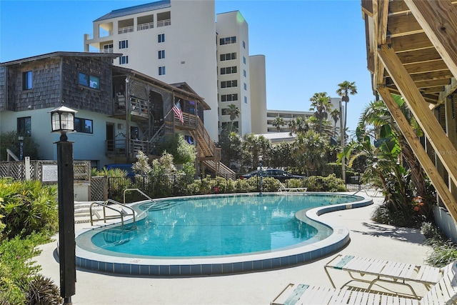 pool featuring stairs and fence