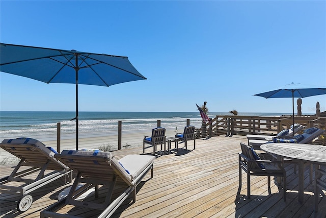 deck featuring a water view and a beach view