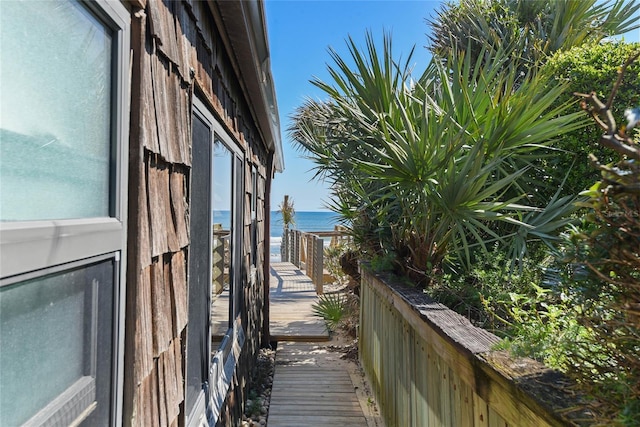 view of home's exterior featuring a balcony and a water view