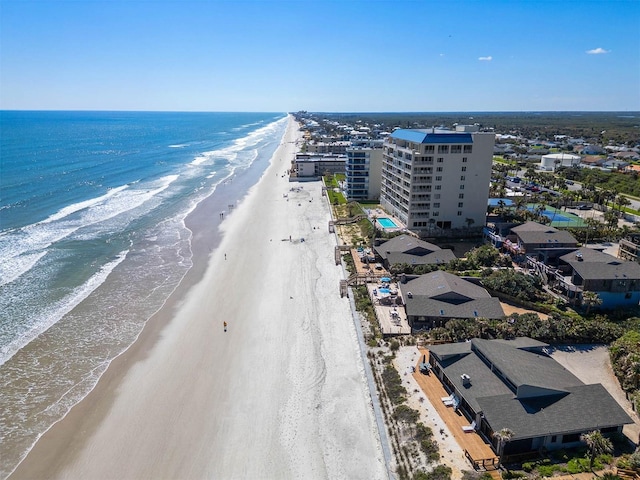 birds eye view of property with a beach view and a water view