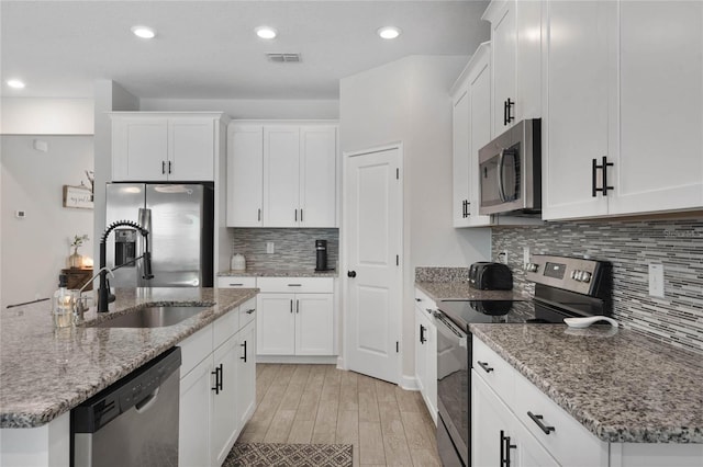 kitchen featuring white cabinetry, visible vents, appliances with stainless steel finishes, and a sink