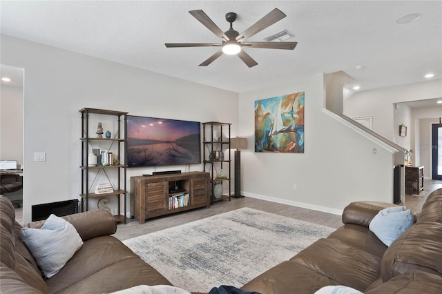 living area with visible vents, baseboards, recessed lighting, wood finished floors, and a ceiling fan