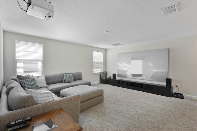 carpeted living room with baseboards, visible vents, and a textured ceiling