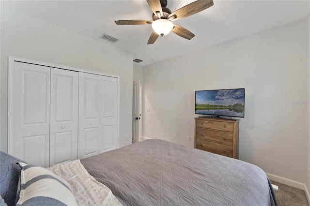 carpeted bedroom featuring a closet, visible vents, ceiling fan, and baseboards